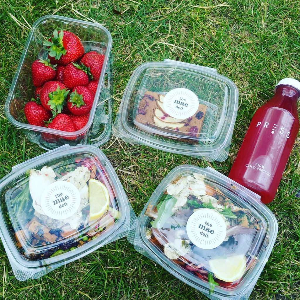 Vegware plant-based pla hinged deli containers filled with salad, pastas, strawberries