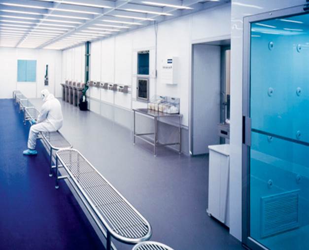 operator gowning in cleanroom cell holding area
