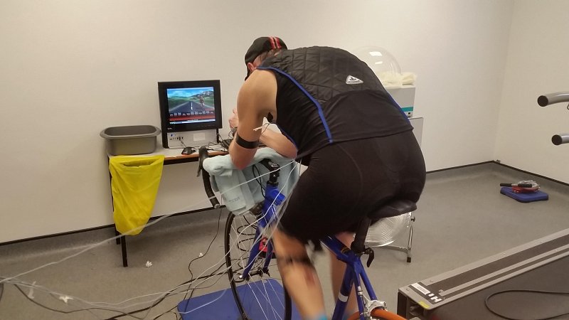 Athlete trainingon stationary bike wearing a cooling vest